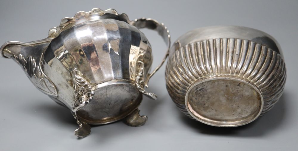 A George IV silver cream jug, London 1823 and an oval half-fluted tea caddy, approx 15oz